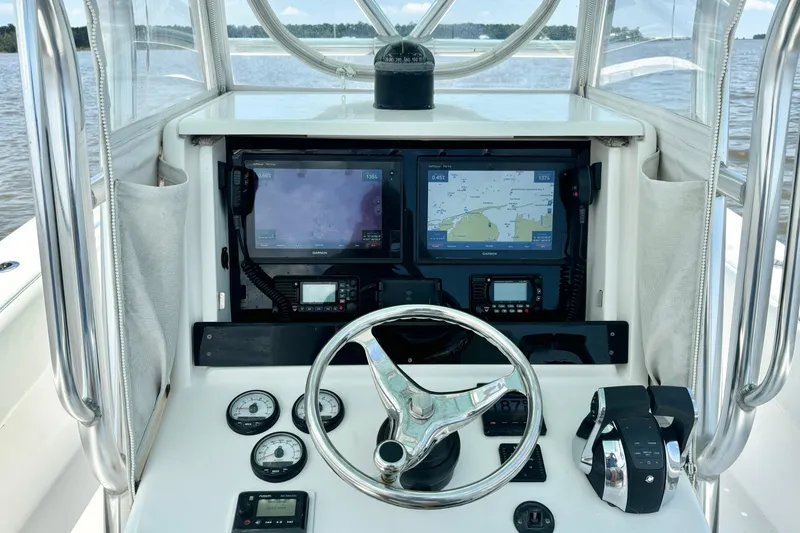 Slide: The Image of Helm of 2008 Invincible 33 Open Fisherman with navigation screens and controls. - 30