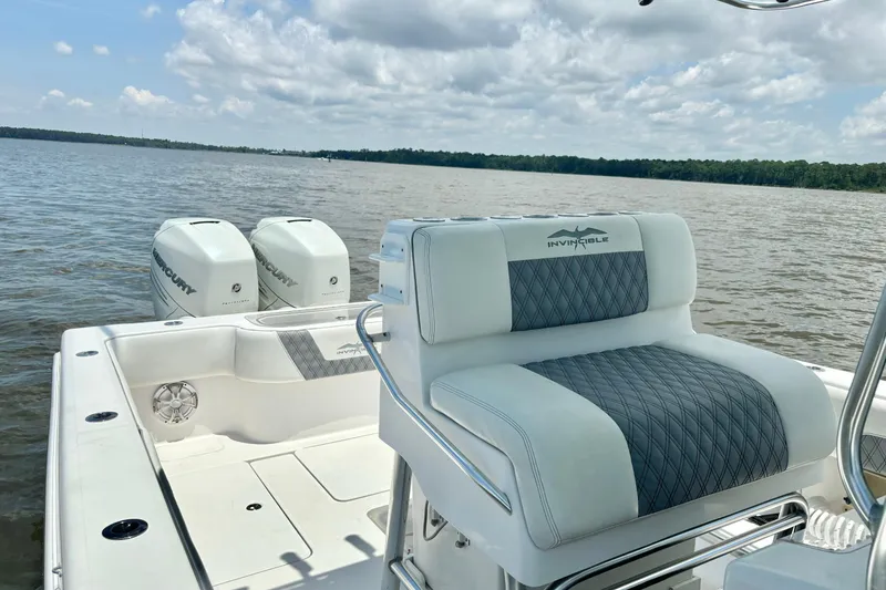 Slide: The Image of 2008 Invincible 33 Open Fisherman boat with dual Mercury engines on a calm lake. - 32