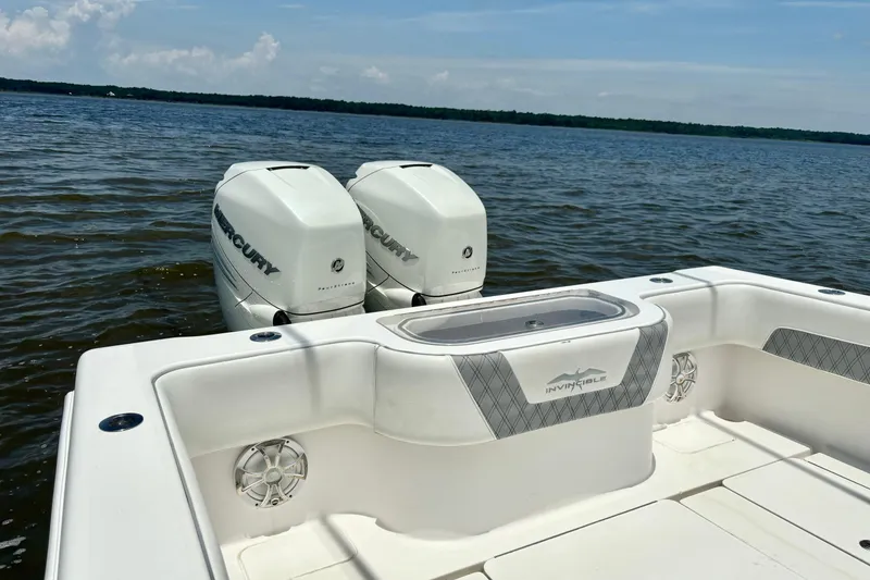 Slide: The Image of 2008 Invincible 33 Open Fisherman boat with twin Mercury engines on a calm lake. - 33