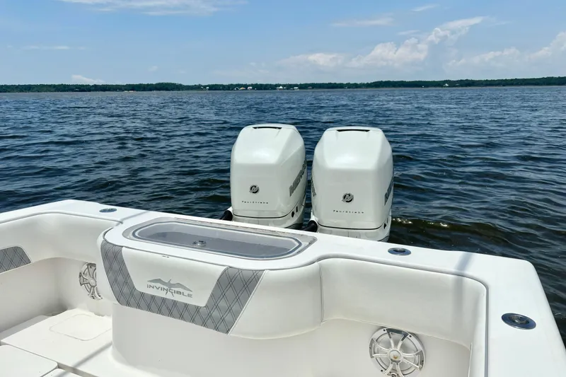 Slide: The Image of 2008 Invincible 33 Open Fisherman boat with twin engines on a calm lake. - 34