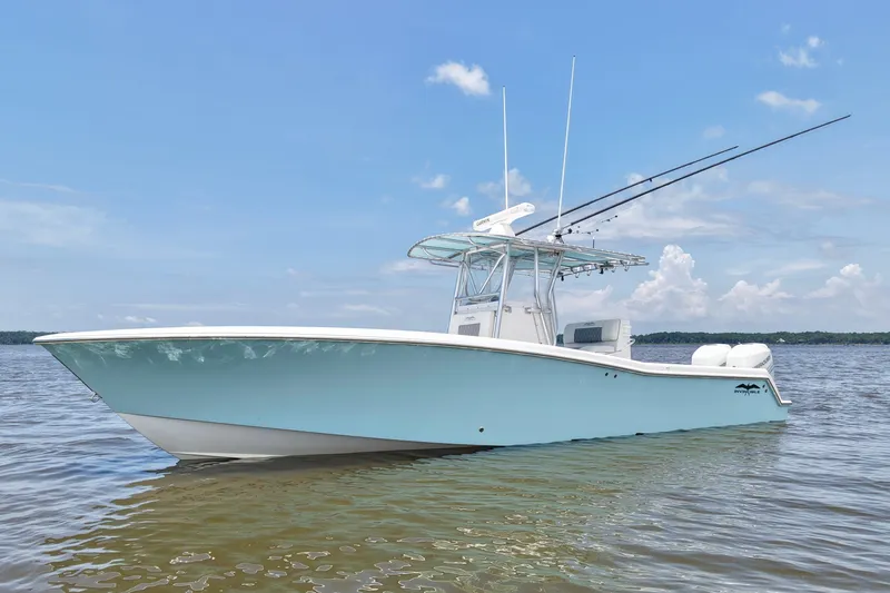 Slide: The Image of 2008 Invincible 33 Open Fisherman boat on calm water under clear blue sky. - 4
