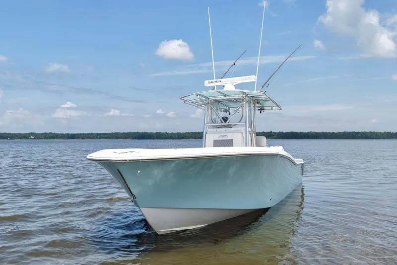 Slide: The Image of 2008 Invincible 33 Open Fisherman boat on calm water under blue sky. - 5
