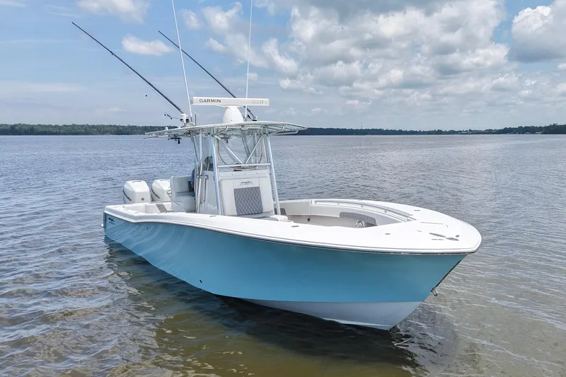 Slide: The Image of 2008 Invincible 33 Open Fisherman boat on calm water under cloudy sky. - 7