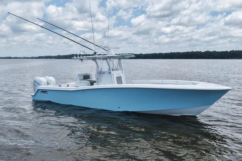 Slide: The Image of 2008 Invincible 33 Open Fisherman boat on calm water under cloudy sky. - 8