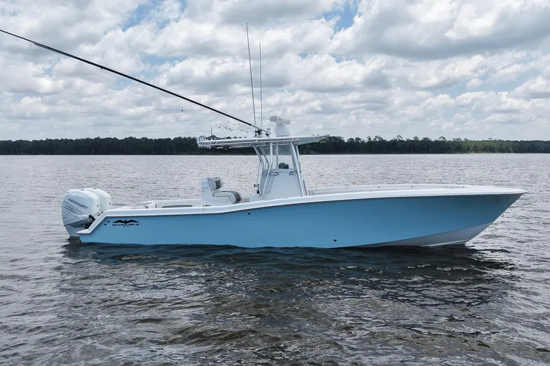 Slide: The Image of 2008 Invincible 33 Open Fisherman boat on calm water under cloudy sky. - 9