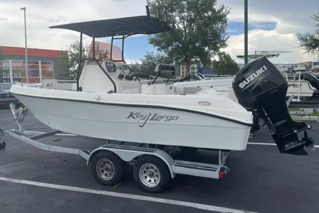 Slide: The Image of 2024 Key Largo 2100 CCW boat on trailer with Suzuki outboard motor. - 1