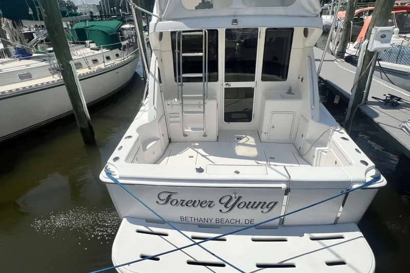 Slide: The Image of 2007 Riviera 33 Flybridge yacht named "Forever Young" docked at Bethany Beach. - 10