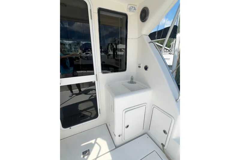 Slide: The Image of 2007 Riviera 33 Flybridge yacht interior with sink and storage compartments. - 11