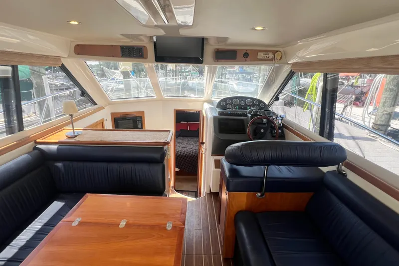 Slide: The Image of Interior of 2007 Riviera 33 Flybridge yacht with helm, seating, and dining area. - 12