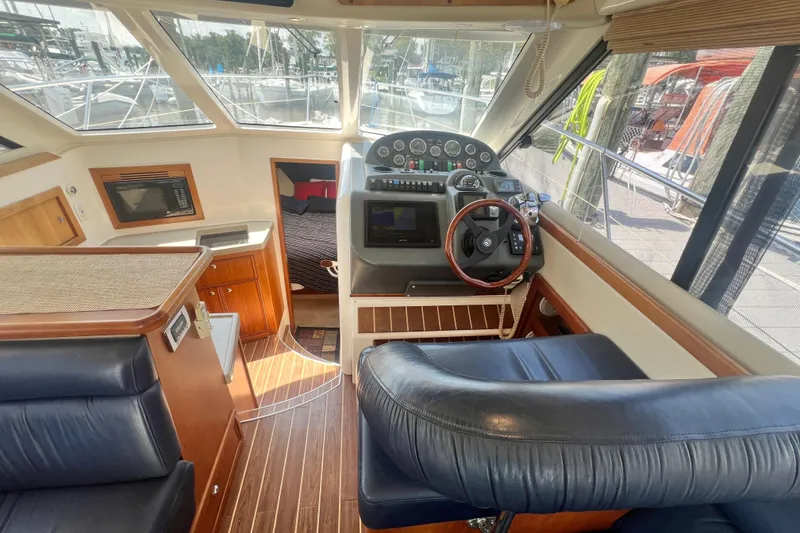 Slide: The Image of Interior view of 2007 Riviera 33 Flybridge yacht with helm and cabin area. - 14