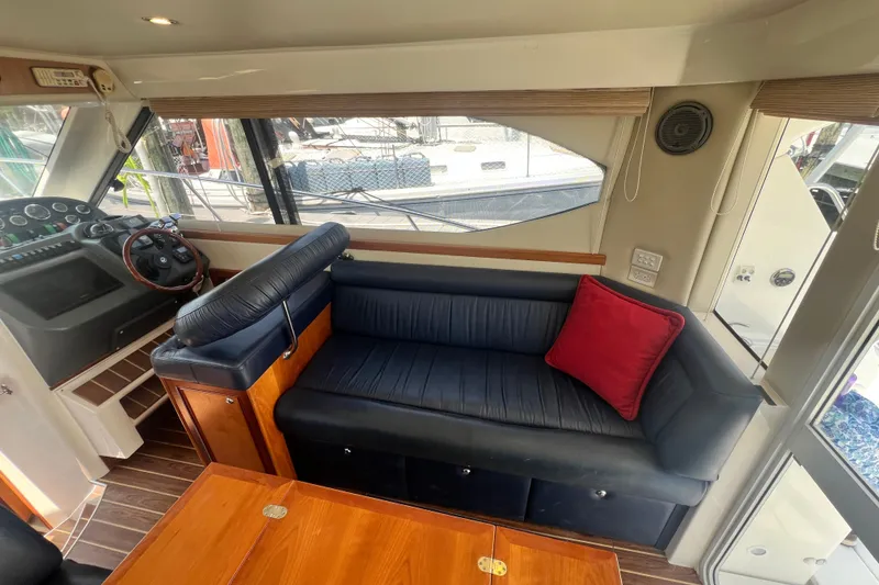 Slide: The Image of Interior of 2007 Riviera 33 Flybridge yacht with leather seating and wooden accents. - 15