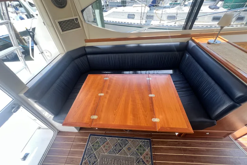 Slide: The Image of Luxurious 2007 Riviera 33 Flybridge interior with elegant wood table and black seating. - 16