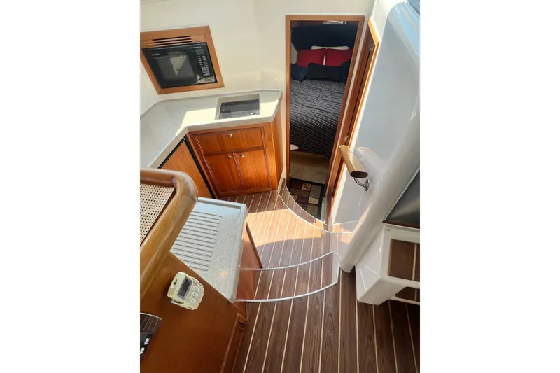 Slide: The Image of Interior of 2007 Riviera 33 Flybridge yacht with kitchen and bedroom view. - 20