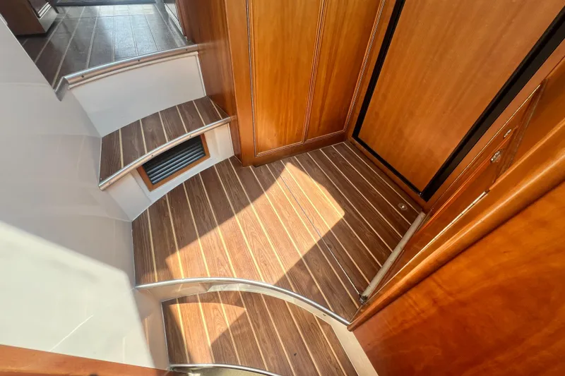 Slide: The Image of Interior of 2007 Riviera 33 Flybridge with wooden flooring and steps. - 24