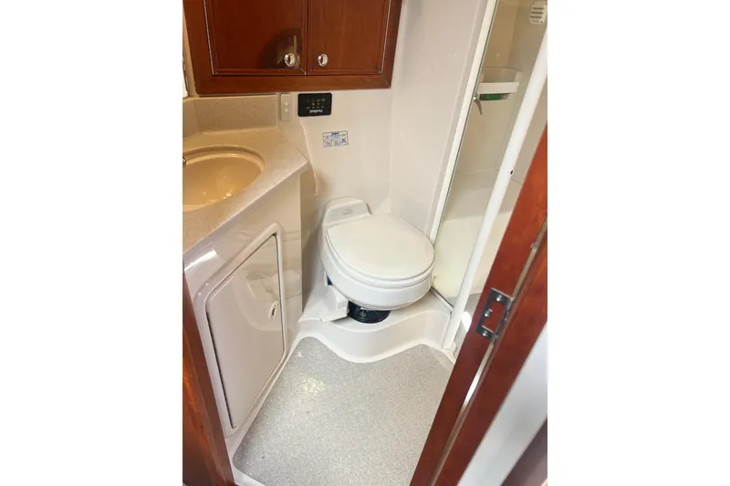 Slide: The Image of 2007 Riviera 33 Flybridge bathroom with toilet, sink, and shower. - 28