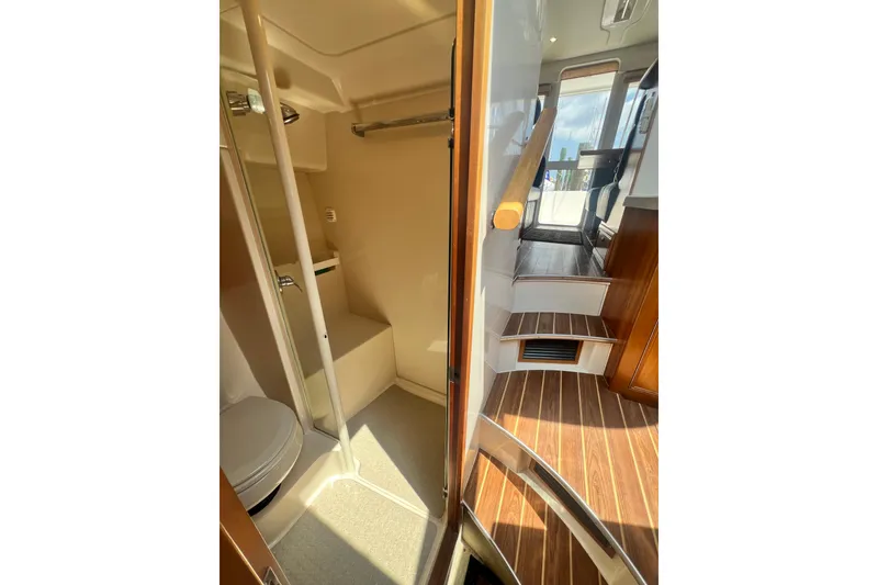 Slide: The Image of Interior of 2007 Riviera 33 Flybridge yacht, featuring bathroom and wooden stairs. - 30