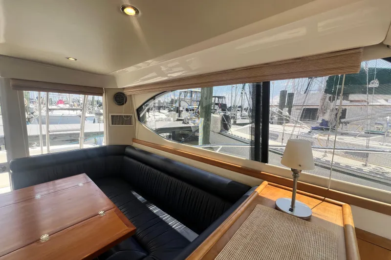 Slide: The Image of Interior of 2007 Riviera 33 Flybridge yacht with elegant seating and marina view. - 32