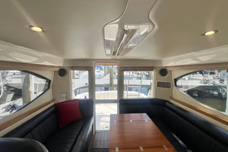 Slide: The Image of Interior of 2007 Riviera 33 Flybridge yacht with elegant seating and wooden table. - 34