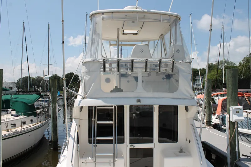 Slide: The Image of 2007 Riviera 33 Flybridge yacht docked at marina, showcasing sleek design and flybridge. - 38