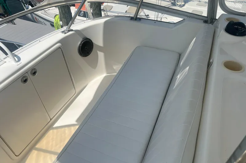 Slide: The Image of 2007 Riviera 33 Flybridge interior with white seating and storage compartments. - 45