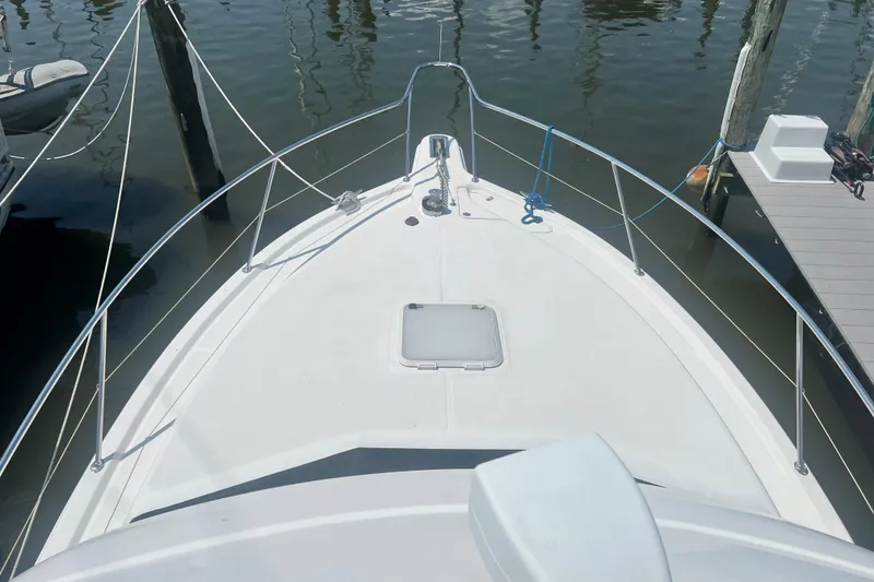 Slide: The Image of Bow view of 2007 Riviera 33 Flybridge yacht docked at marina. - 46