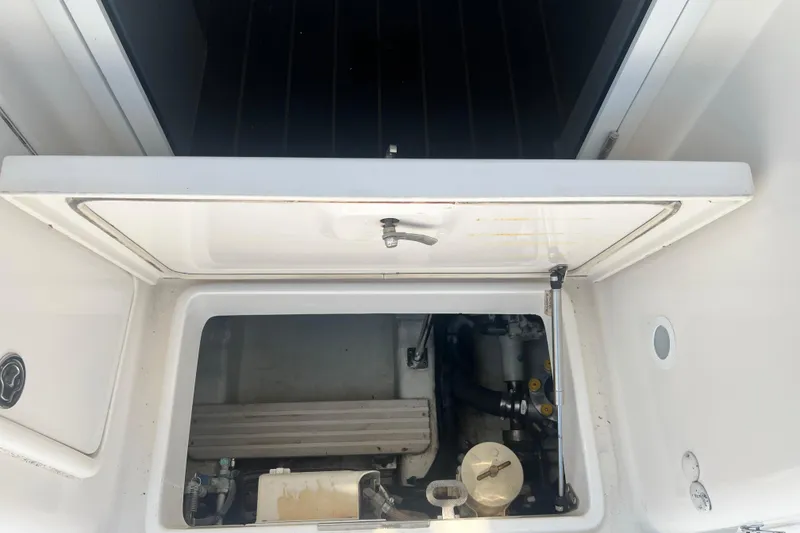 Slide: The Image of Engine compartment of a 2007 Riviera 33 Flybridge boat, showcasing mechanical components. - 52