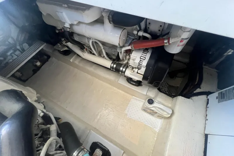 Slide: The Image of Engine compartment of a 2007 Riviera 33 Flybridge boat, showcasing mechanical components. - 53