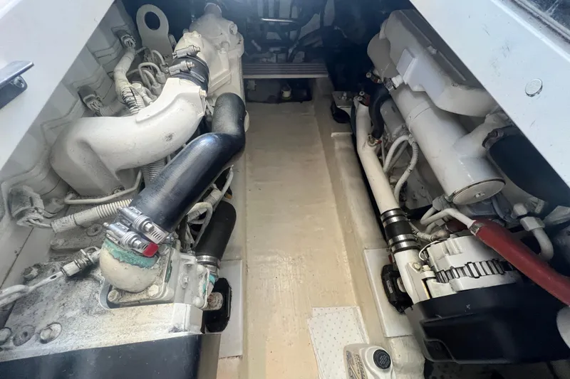 Slide: The Image of Engine compartment of a 2007 Riviera 33 Flybridge boat, showcasing mechanical components. - 54