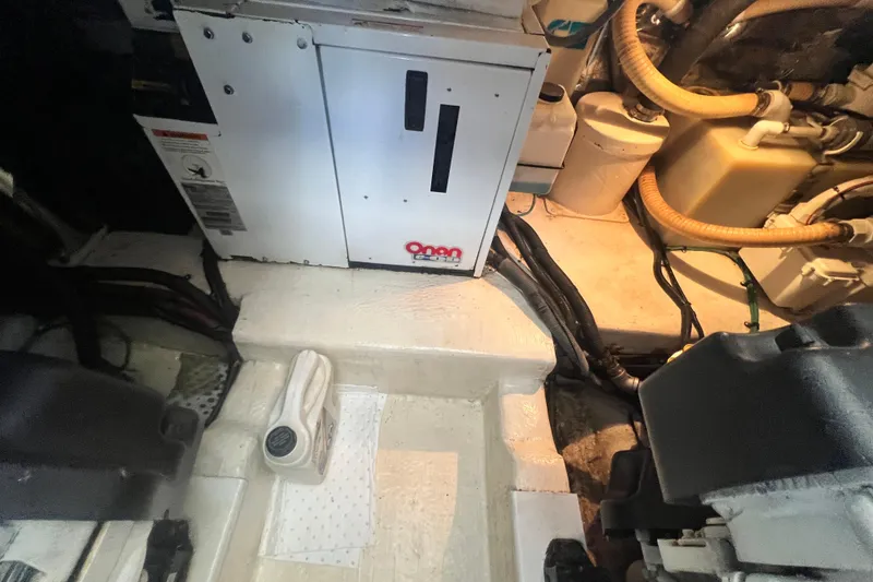Slide: The Image of Engine room of 2007 Riviera 33 Flybridge with Onan generator and mechanical components. - 56