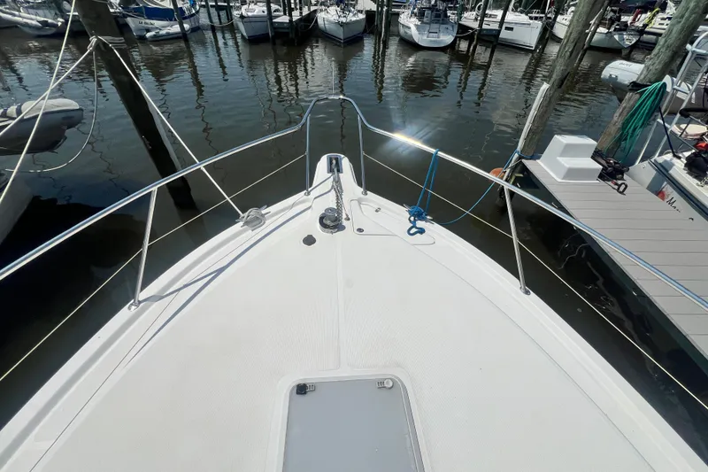 Slide: The Image of Bow view of 2007 Riviera 33 Flybridge yacht docked at marina. - 58