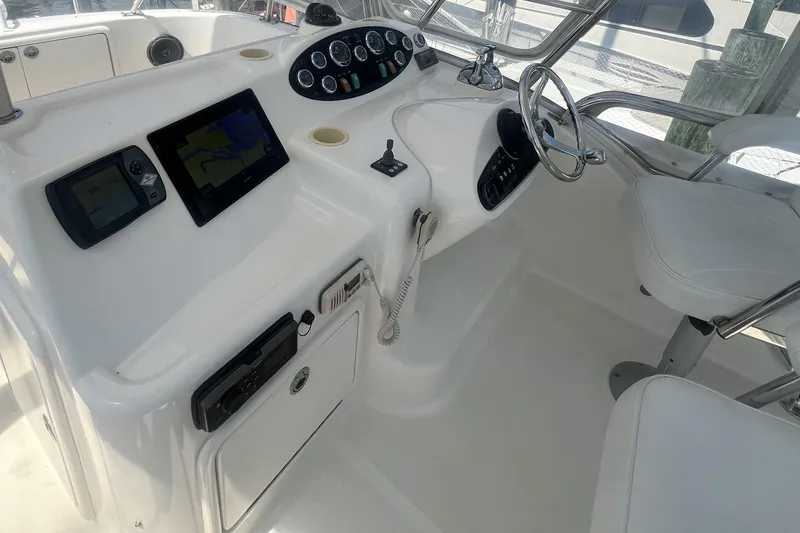 Slide: The Image of 2007 Riviera 33 Flybridge helm with navigation screens and steering wheel. - 43