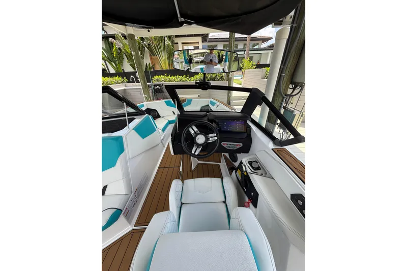 Slide: The Image of 2024 Nautique Super Air Nautique GS20 boat interior with modern dashboard and seating. - 13