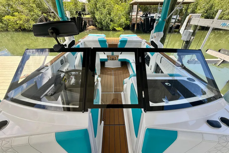 Slide: The Image of 2024 Nautique Super Air Nautique GS20 boat interior with teal accents and sleek design. - 17