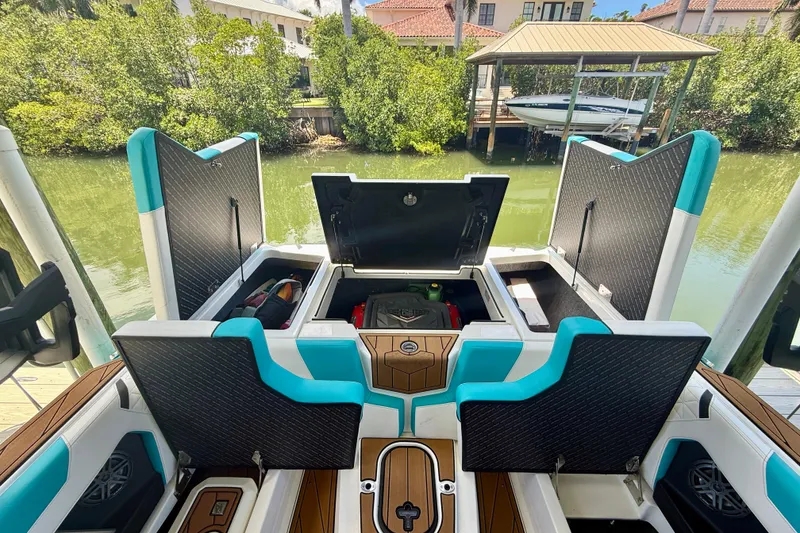 Slide: The Image of 2024 Nautique Super Air Nautique GS20 boat interior with open storage compartments. - 21