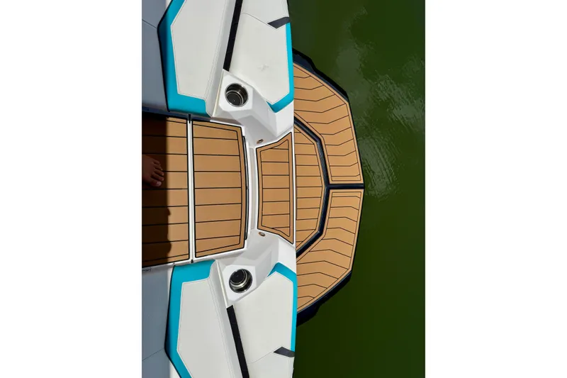 Slide: The Image of 2024 Nautique Super Air Nautique GS20 boat deck with teak finish on green water. - 22