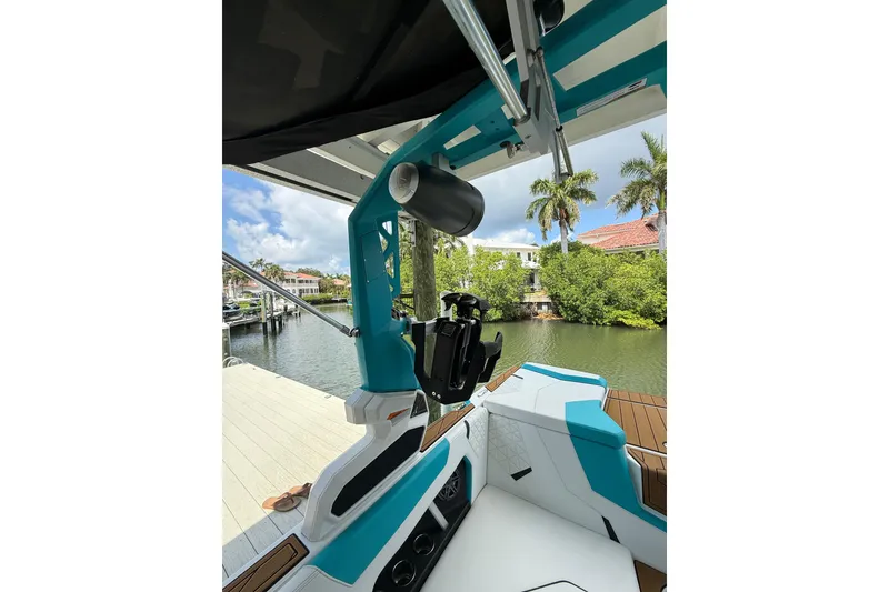 Slide: The Image of 2024 Nautique Super Air Nautique GS20 boat interior with teal accents and speaker system. - 27