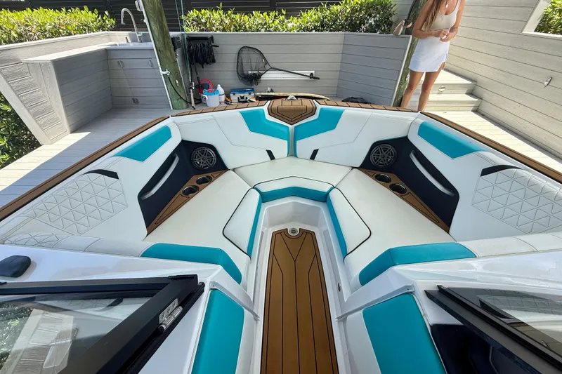 Slide: The Image of 2024 Nautique Super Air Nautique GS20 boat interior with teal and white seating. - 32
