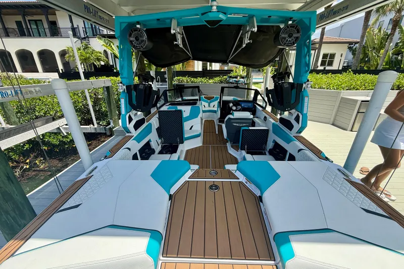 Slide: The Image of 2024 Nautique Super Air Nautique GS20 boat interior with modern design and teal accents. - 34
