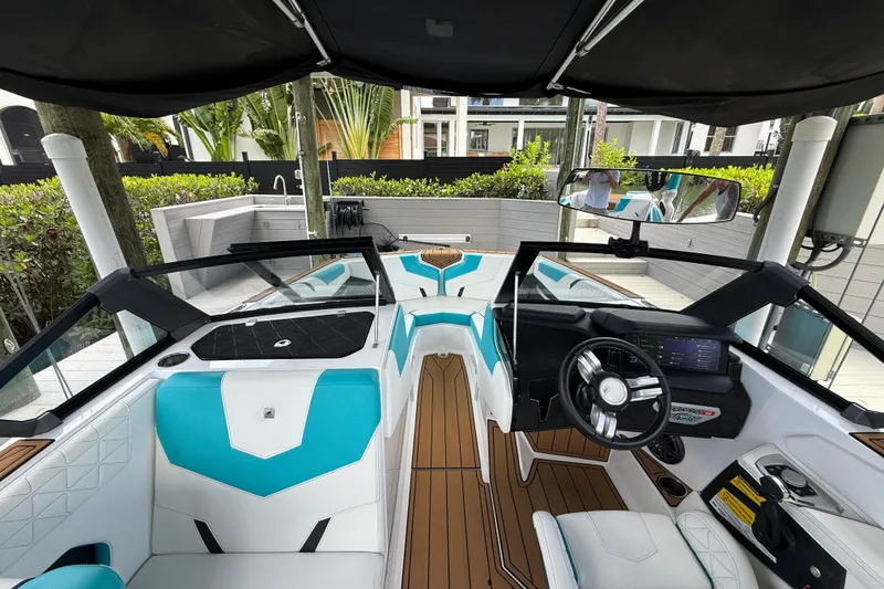 Slide: The Image of 2024 Nautique Super Air Nautique GS20 interior with modern dashboard and turquoise seating. - 6