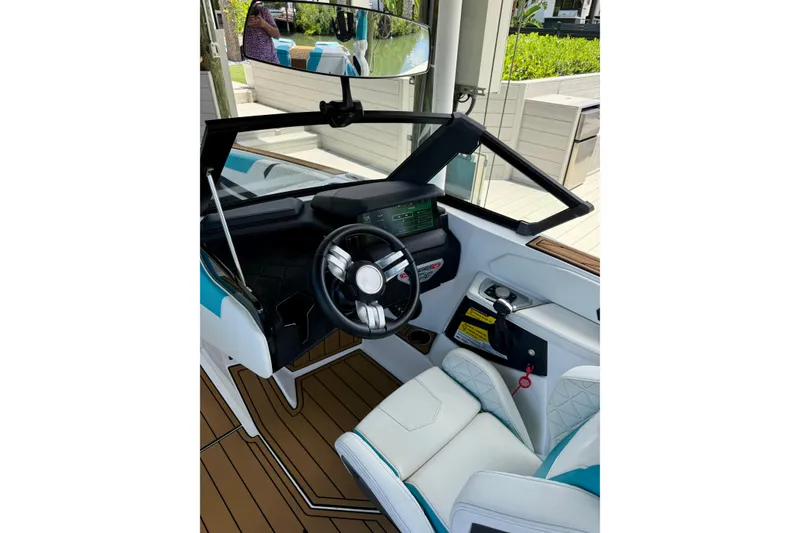 Slide: The Image of 2024 Nautique Super Air Nautique GS20 cockpit with modern steering and dashboard design. - 7