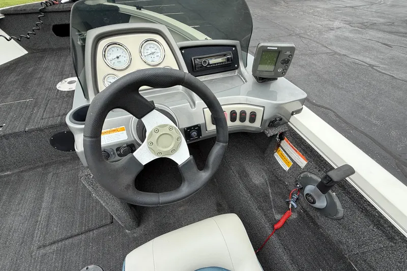 Slide: The Image of 2011 Lowe Fishing Machine 175 dashboard with steering wheel and control panel. - 10