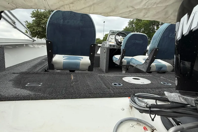 Slide: The Image of 2011 Lowe Fishing Machine 175 interior with blue seats and steering console. - 3
