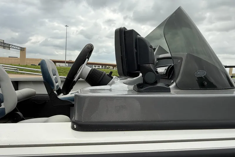 Slide: The Image of 2011 Lowe Fishing Machine 175 boat dashboard with steering wheel and controls. - 5