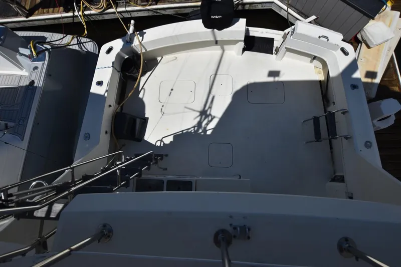 Slide: The Image of 1983 Hatteras 50 Convertible boat deck, spacious and well-equipped for fishing or leisure activities. - 10