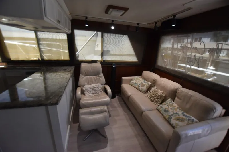 Slide: The Image of Luxurious interior of 1983 Hatteras 50 Convertible yacht with plush seating and elegant decor. - 11