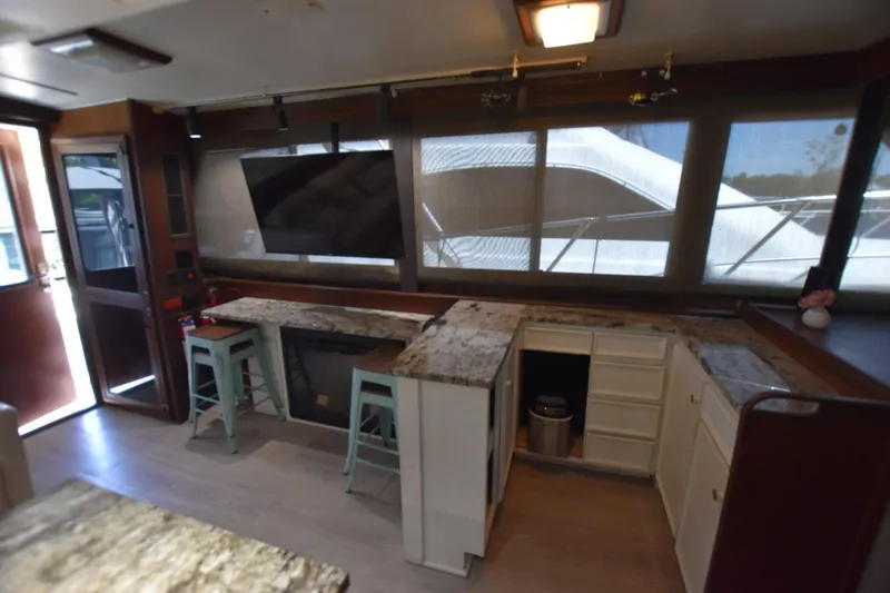 Slide: The Image of Interior of 1983 Hatteras 50 Convertible yacht with modern kitchen and seating area. - 12