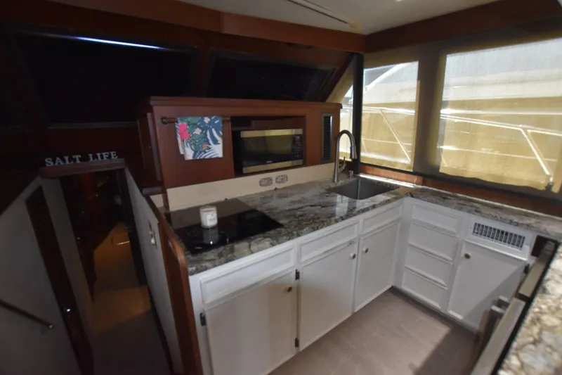 Slide: The Image of 1983 Hatteras 50 Convertible yacht kitchen with granite countertops and modern appliances. - 15