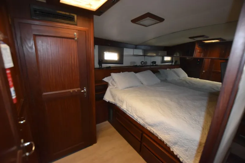 Slide: The Image of Luxurious cabin interior of 1983 Hatteras 50 Convertible yacht with cozy bedding. - 17