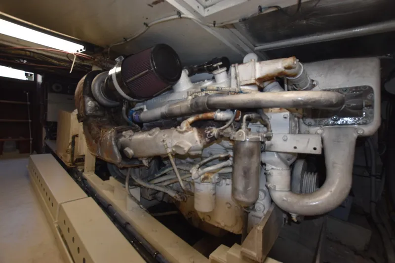 Slide: The Image of Engine room of a 1983 Hatteras 50 Convertible yacht, showcasing machinery and components. - 27