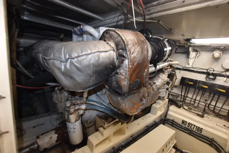 Slide: The Image of Engine room of 1983 Hatteras 50 Convertible yacht, showcasing machinery and components. - 28